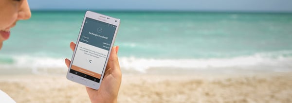 holding-mobile-app-at-beach