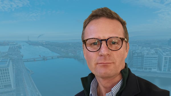 Jan Lorenc CEO in front of background of a Dublin cityscape 