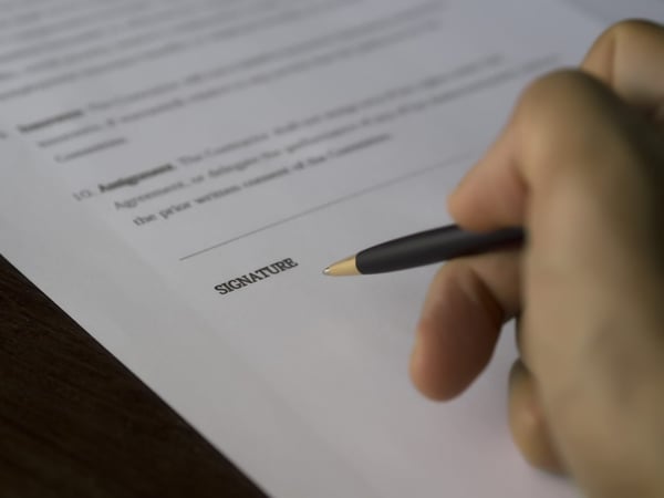 A person filling out a form.