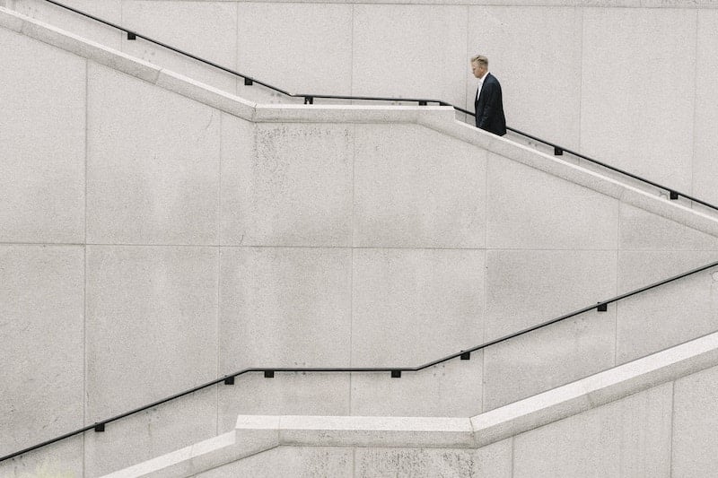 A man walking up a set of stairs.