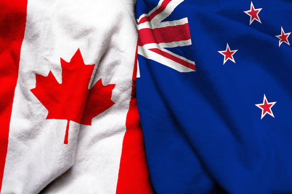 Canadian and New Zealand flags beside each other. 