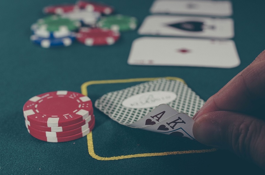 poker-hand-and-chips-casino 