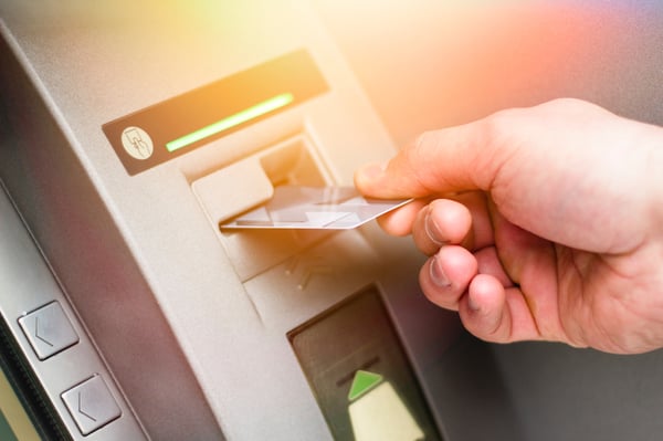 man-inserting-card-into-atm