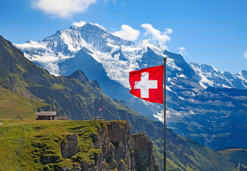 swiss-alps-with-flag-in-foreground