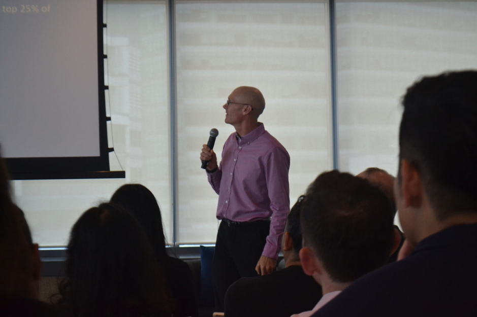 photo of andrew hallam presenting with microphone