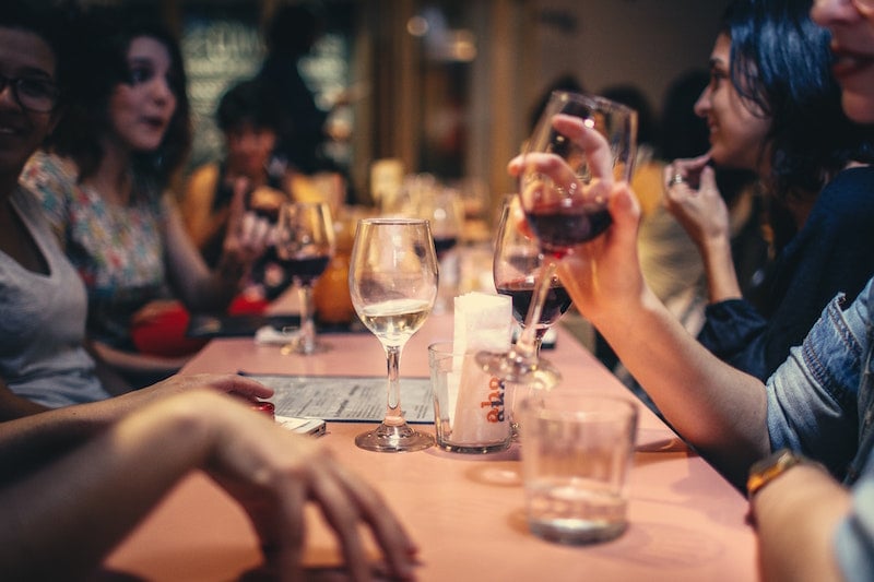 people talking over dinner at table