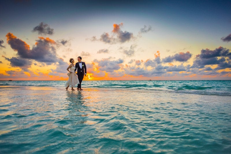 bridal couple walking on beach