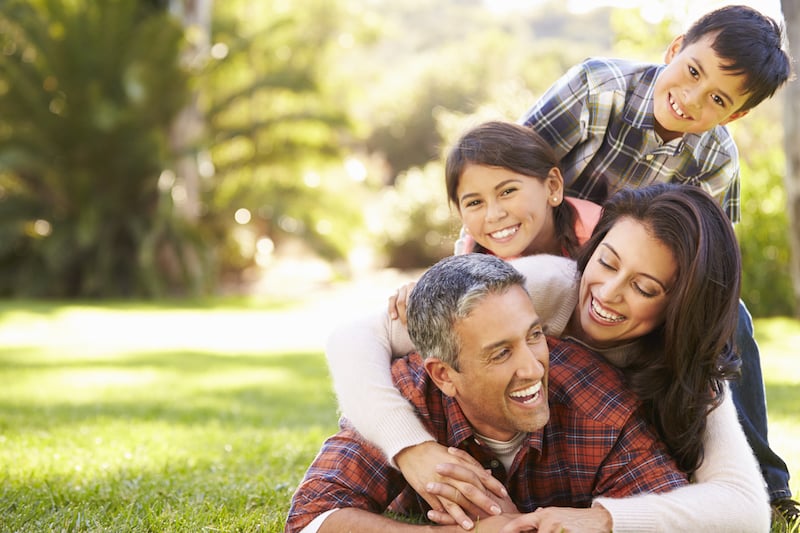 family laughing on grass