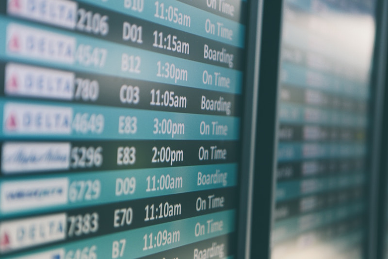 fight arrival departure board in airport blurred