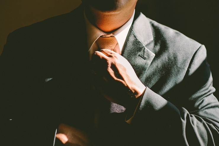 man-straightening-tie