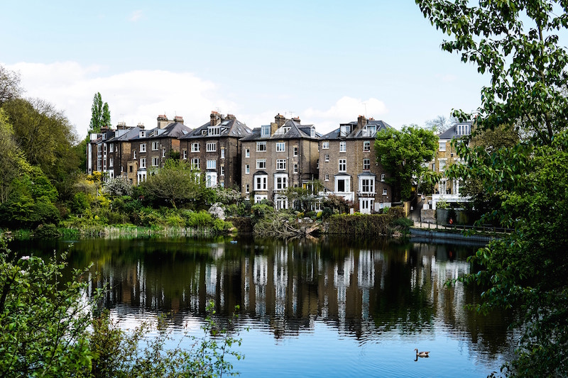 row of old english houses at lakeside