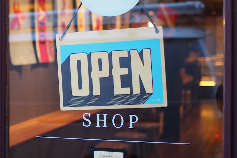 retro open shop sign in glass window