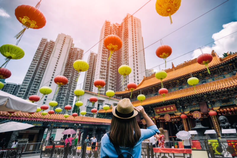 woman wearing hat on street in hong kong